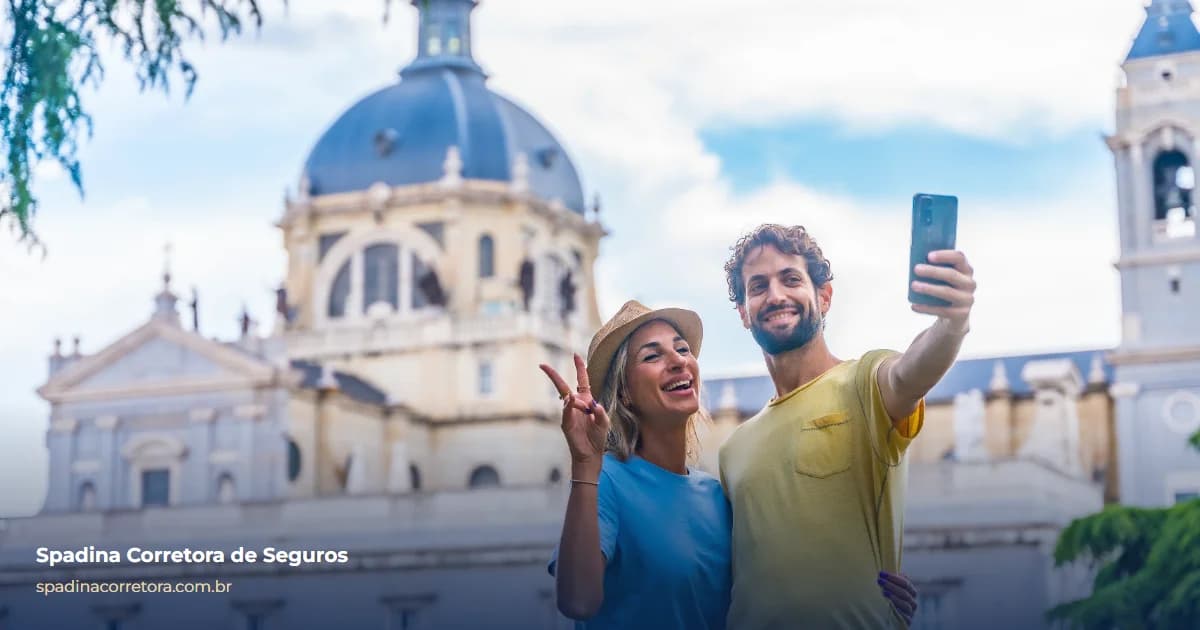 Casal de turistas sorrindo e tirando uma selfie em frente a um edifício histórico em Madri, na Europa